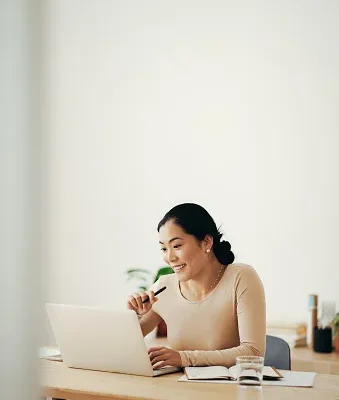 happy business woman working from home on laptop computer