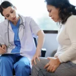 portrait of a female doctor talking to a patient with knee pain